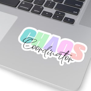 May include: A sticker with the text "CHAOS Coordinator" in colourful letters on a white background. The letters are in different colours, including pink, blue, green, and yellow.