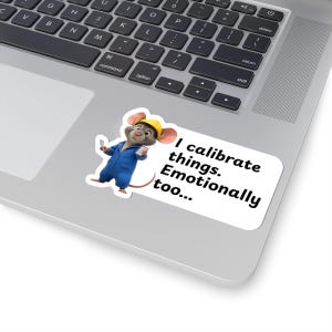 May include: A white sticker with the text "I calibrate things. Emotionally too..." is on a laptop. The sticker shows a cartoon mouse in a blue jumpsuit and a yellow hard hat.