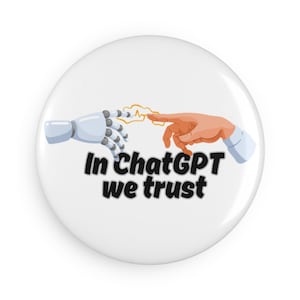 May include: A white button featuring a cartoon illustration of a robotic hand and a human hand touching. The text "In ChatGPT we trust" is displayed beneath the image.