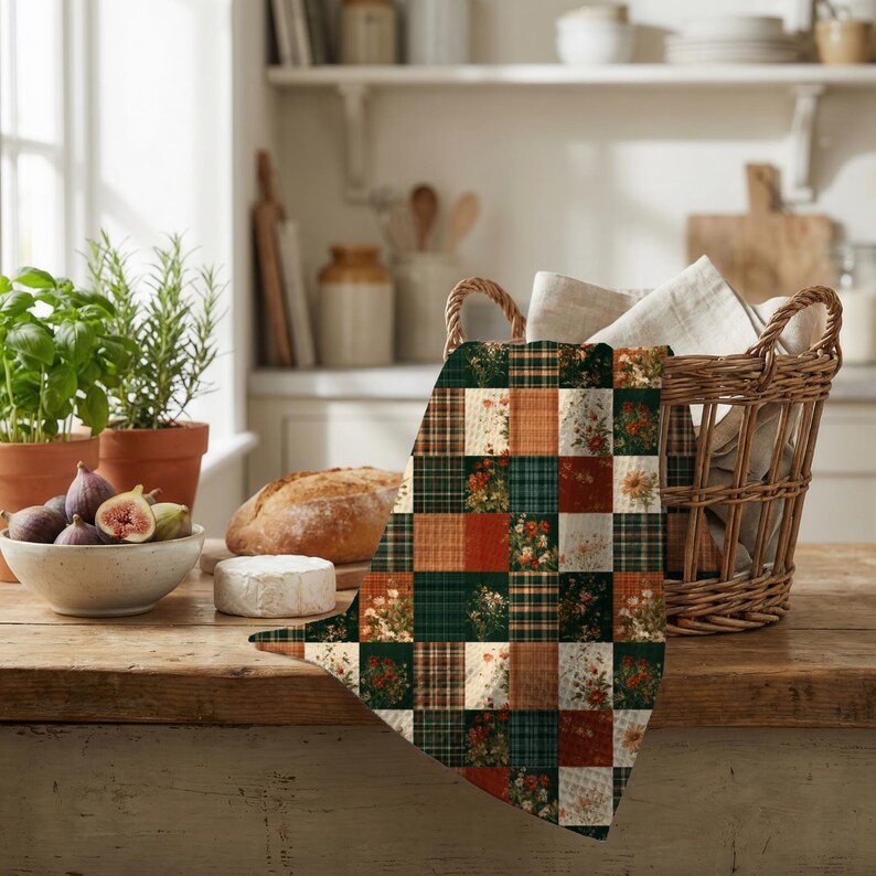 May include: A rectangular kitchen towel featuring a patchwork design of alternating squares. The pattern consists of dark green, burnt orange, and cream colors, incorporating floral illustrations and plaid textures throughout the fabric surface.