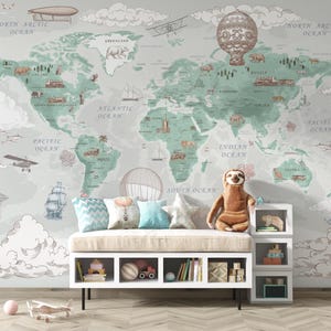 May include: A pastel-toned world map mural with illustrations of airships, aeroplanes, and sailing vessels. A white bench with cushions and a sloth toy is positioned in front of the mural, ideal for a nursery or playroom setting.