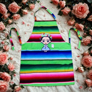 Colorful Mexican Serape Apron with Cute Baby Frida Doll Embroidery – Handmade Kitchen Apron with Pockets. Frida Sarape Apron. Mexican Apron