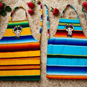 Handmade Mexican Apron with Muñequita Doll Embroidery – Colorful Serape Fabric Kitchen Apron with Pockets. Mexican Doll Sarape Apron