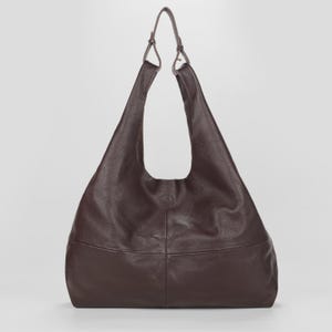 Oversized dark brown leather hobo bag with a soft slouchy silhouette and elegant minimalist design. Premium genuine leather shoulder tote featuring a spacious large capacity interior, rich espresso brown color, pebbled leather texture, and adjustable shoulder straps. Chic quiet luxury handbag perfect for work, travel, shopping, and everyday use. Stylish oversized leather tote purse, designer inspired carryall bag, handmade shoulder handbag, laptop friendly work tote, modern minimalist fashion