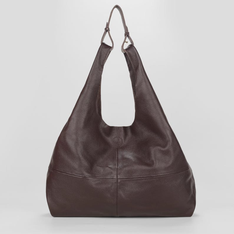 Oversized dark brown leather hobo bag with a soft slouchy silhouette and elegant minimalist design. Premium genuine leather shoulder tote featuring a spacious large capacity interior, rich espresso brown color, pebbled leather texture, and adjustable shoulder straps. Chic quiet luxury handbag perfect for work, travel, shopping, and everyday use. Stylish oversized leather tote purse, designer inspired carryall bag, handmade shoulder handbag, laptop friendly work tote, modern minimalist fashion