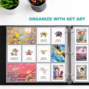 May include: A black binder with clear card sleeves filled with various Pok&eacute;mon trading cards. The cards feature colorful illustrations of Pok&eacute;mon characters and the text "ORGANIZE WITH SET ART". The binder is open, displaying multiple cards.