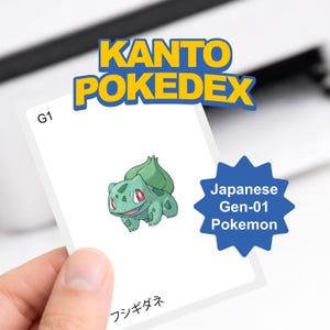 May include: A card featuring a green Bulbasaur illustration from the Kanto Pokedex. The card has the text "Kanto Pokedex" and "Japanese Gen-01 Pokemon". The card is held by a person.