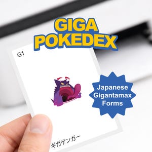 May include: A white card with a purple and pink Gigantamax Gengar illustration, held by a hand. The card has the text "GIGA POKEDEX" in yellow and blue, and "Japanese Gigantamax Forms" on a blue starburst.