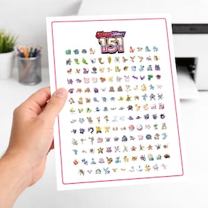 May include: A white print featuring the text "Scarlet & Violet 151" above a grid of colorful cartoon characters. The print has a pink border and is held by a person's hand.