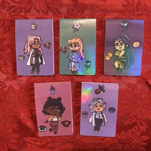 May include: Five rectangular stickers with cartoon illustrations. The stickers feature characters with various hairstyles and outfits, along with food and drink icons. The backgrounds are shades of purple and green, with some holographic elements.