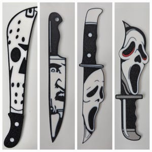 May include: Four different Halloween-themed knives with black handles and white blades. The blades feature iconic horror movie characters: Jason Voorhees, Michael Myers, and Ghostface.