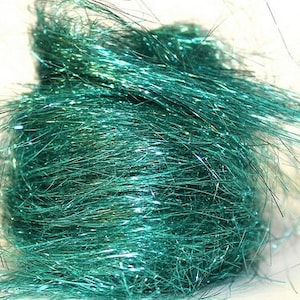 May include: A bundle of teal iridescent fibre for crafting. The fibres are long and thin, with a shimmery finish.