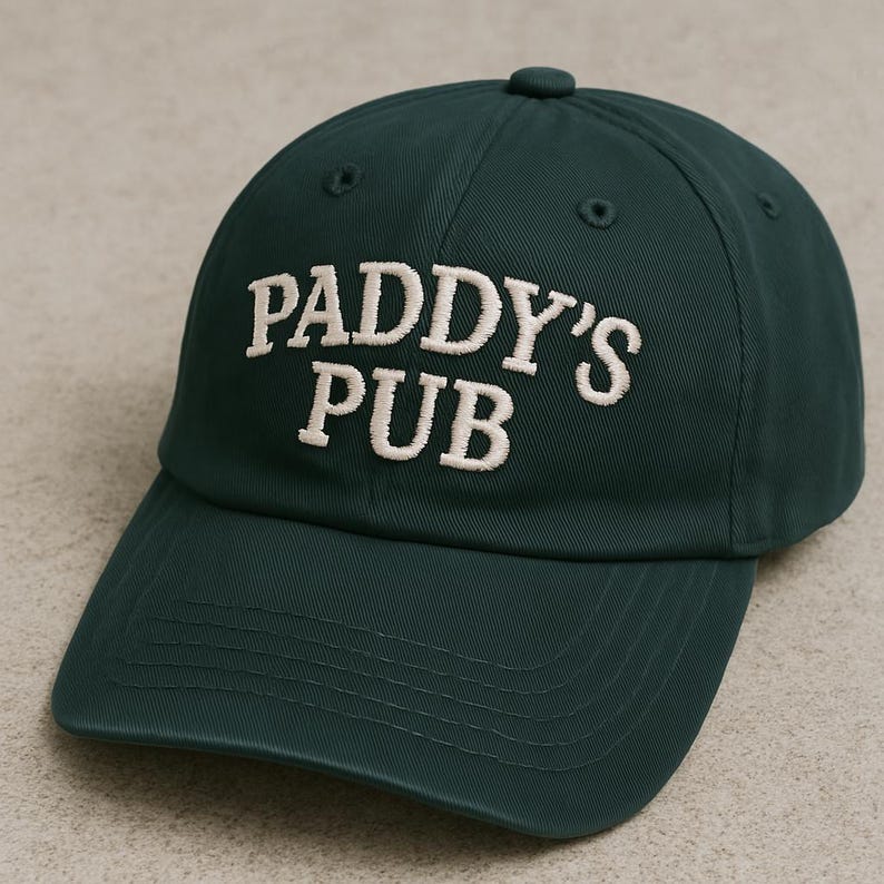 May include: A dark green baseball cap with the text "PADDY'S PUB" embroidered in white.