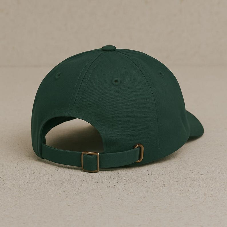 May include: A dark green baseball cap with a brown adjustable strap and buckle.