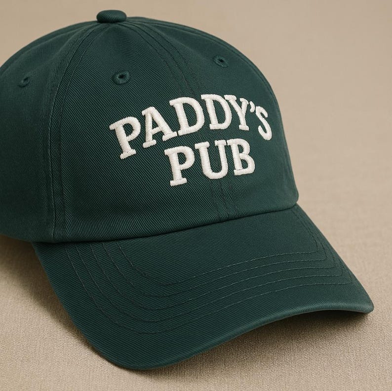 May include: A dark green baseball cap with white embroidered text that reads "PADDY'S PUB".