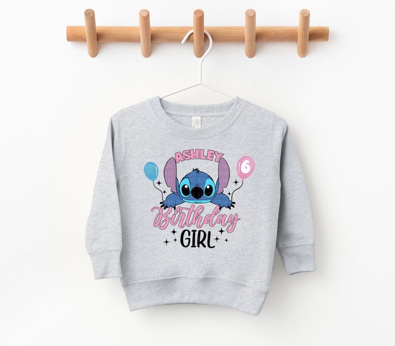 a gray sweatshirt with a cartoon character on it