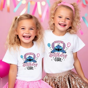 two little girls standing next to each other