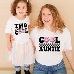 a woman and a little girl standing next to each other