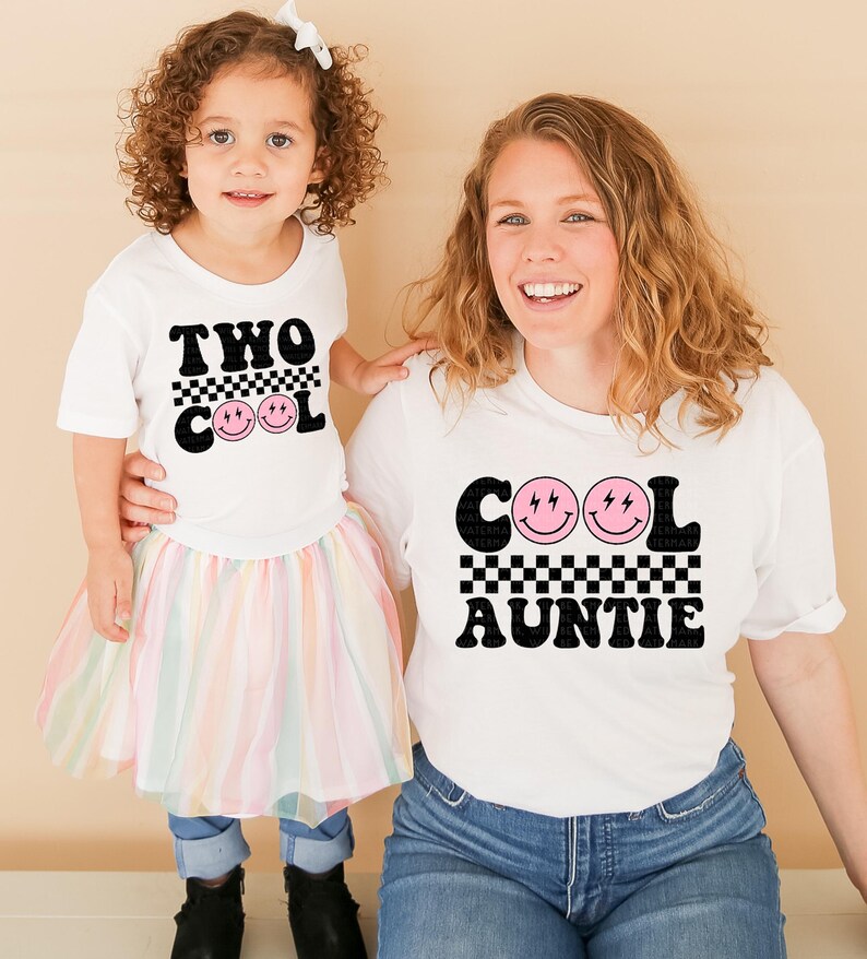 a woman and a little girl standing next to each other