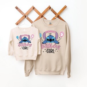 a couple of sweatshirts hanging on a wall