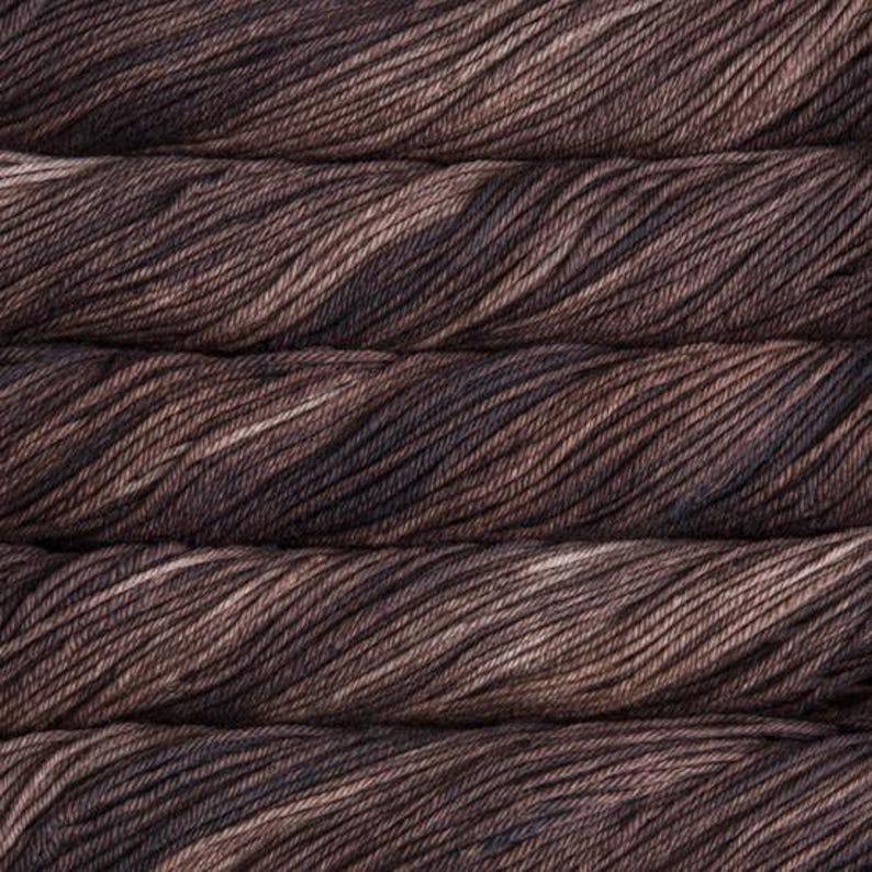 Malabrigo Rios Coco Tonal Espresso Superwash Merino Yarn skeins stacked, showcasing soft brown and dark brown hues with subtle texture, from Malabrigo, a premium yarn brand known for quality and color.