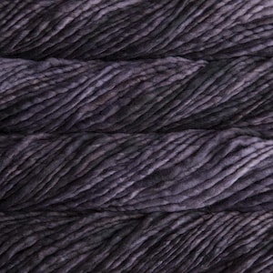 May include: Close-up of a skein of dark purple yarn with a textured, slightly uneven surface. The yarn appears thick and chunky, with variations in color and tone, creating a rich, dimensional appearance. Ideal for knitting and crochet projects.