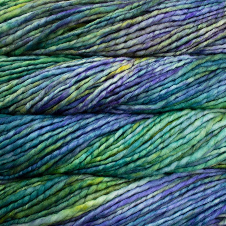 May include: Close-up of hand-dyed yarn in shades of blue, green, purple, and yellow. The yarn appears thick and textured, with variations in color throughout. Ideal for knitting, crocheting, or other fiber arts projects.