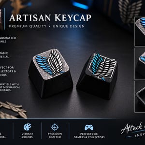 May include: Two black mechanical keyboard keycaps featuring the Wings of Freedom emblem with blue and white wings. The keycaps have a textured metallic finish on the top surface and a standard cross-shaped stem on the underside for mounting.