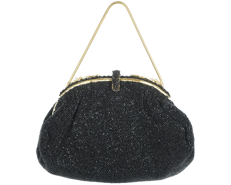 May include: A black beaded evening bag with a gold chain strap and a gold clasp.