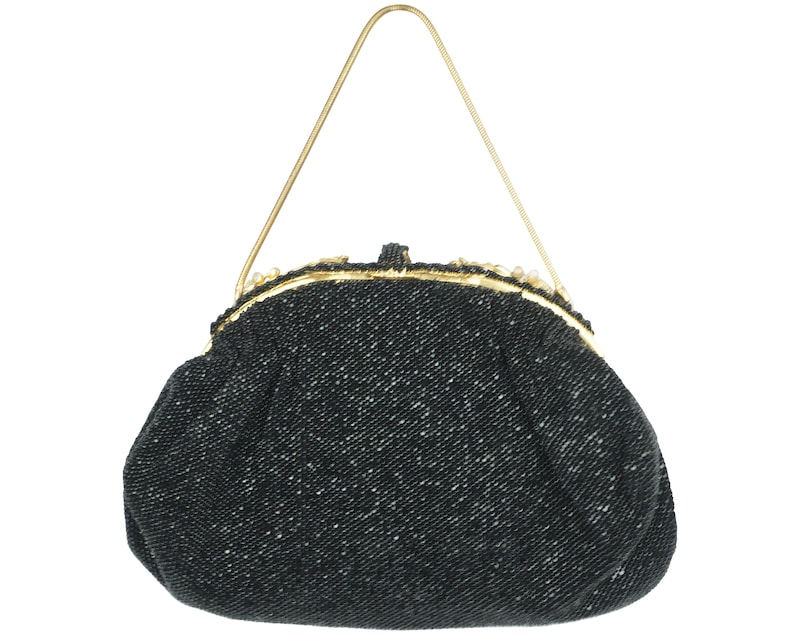 May include: A black beaded evening bag with a gold clasp and chain strap.