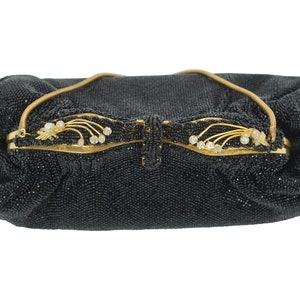May include: A black beaded evening bag with a gold clasp and a decorative floral design. The clasp features small white stones.