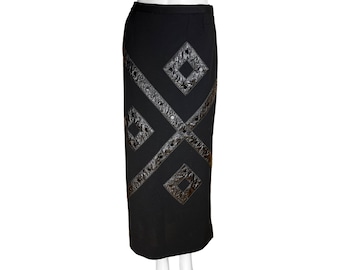 May include: Black skirt with a geometric design of black leather straps and studded details.