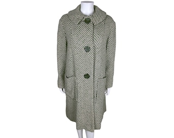 May include: A long black and white checkered coat with a collar and three black buttons. The coat has two pockets on the front.