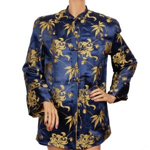 May include: A navy blue jacket with gold floral embroidery and a mandarin collar. The jacket has a front closure with decorative buttons.