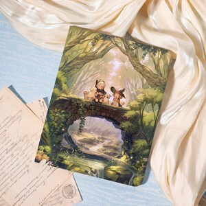 May include: A rectangular print featuring a digital illustration of two figures with small animals sitting on a stone bridge over a stream in a lush green forest. The artwork displays soft lighting, detailed foliage, and a serene woodland atmosphere.
