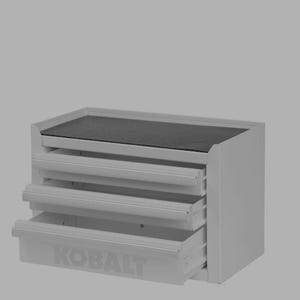 May include: A gray, three-drawer tool chest with a black top surface. The bottom drawer is partially open, revealing the "KOBALT" logo. The chest is designed for tool storage and organization.
