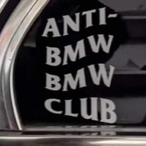 May include: A black and white sticker on a car window that reads "ANTI-BMW BMW CLUB".