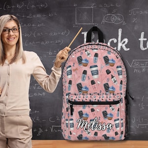 May include: A pink backpack featuring a repeating pattern of coffee cups, cupcakes, and makeup items. The front pocket displays the name Melissa in white cursive script. The bag includes a top handle, black zippers, and side mesh pockets for storage.
