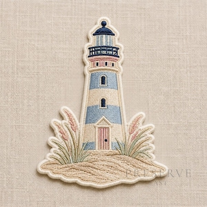 May include: Embroidered patch featuring a lighthouse with blue and white stripes, a pink top, and a dark blue lantern room. The lighthouse is set on a sandy base with decorative grasses.
