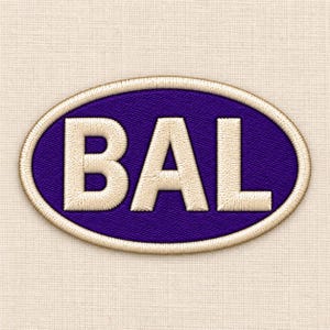 May include: An oval-shaped embroidered patch featuring a deep purple background with the letters BAL stitched in a light cream color. The patch is finished with a thick, raised cream-colored border that outlines the entire oval shape.