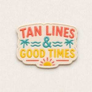 May include: An embroidered patch with a cream background featuring the text TAN LINES in coral, an ampersand in teal, and GOOD TIMES in yellow. The design includes two teal palm trees, two teal wavy lines, and a yellow sun with coral rays.