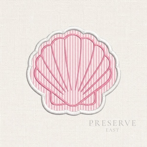 May include: An embroidered patch in the shape of a seashell, featuring a pink and white vertical striped pattern. The shell design is outlined in pink thread, and the entire patch is bordered by a thick, white scalloped edge on a fabric base.