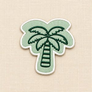 May include: A palm tree embroidered patch featuring a light green and white vertical pinstripe background. The palm tree design is outlined and detailed in dark green thread, with a white stitched border surrounding the entire shape.