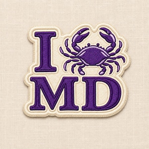 May include: An embroidered patch featuring the text I, a purple crab icon, and the text MD. The letters and crab are deep purple with a thick, cream-coloured border and background, creating a cohesive design suitable for attachment to fabric items.