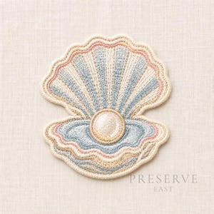 May include: Embroidered seashell patch with a pearl. The design features a light blue and cream shell with pink accents and a central pearl. The text "PRESERVE EAST" is at the bottom.