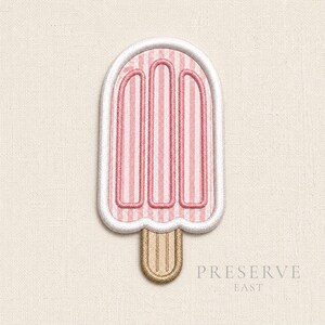 May include: An embroidered patch shaped like a popsicle with a white border. The popsicle features a pink and white vertical striped pattern with three rounded vertical segments. A tan wooden stick extends from the bottom. The text PRESERVE EAST is visible.