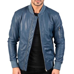 May include: A blue leather bomber jacket with a zipper closure and a zippered pocket on the left sleeve.