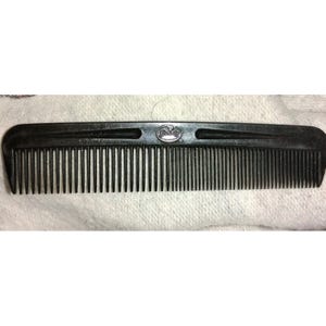 May include: A black plastic comb with fine teeth. The comb has a curved top with a small logo in the center. The teeth are evenly spaced and run the length of the comb. A practical hair care tool.