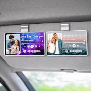 May include: Two rectangular car visor clips with personalized photo and music player interface designs. One features a couple with the text "Drive Safe, I Love you." The other displays a couple with the text "Come home safe, my Love."