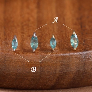 May include: Four marquise-cut teal gemstone studs arranged in a row. The two outer stones are labeled with the letter A, and the two inner stones are labeled with the letter B. Each gemstone is set in a small metal prong setting.